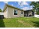 Green backyard with a screened-in patio and a clothes drying rack, perfect for relaxation and outdoor activities at 2409 Martins Run, Tavares, FL 32778