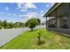 Landscaped backyard with healthy green lawn, white vinyl fence, and screened-in lanai at 2409 Martins Run, Tavares, FL 32778