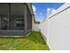The spacious backyard featuring a white vinyl fence and a covered screened-in lanai at 2409 Martins Run, Tavares, FL 32778
