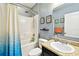 A full bathroom featuring a shower-tub combo with white tiling and a cultured marble vanity at 2409 Martins Run, Tavares, FL 32778
