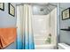 Full bathroom featuring a shower-tub combo with a rain-style shower head and white tiling at 2409 Martins Run, Tavares, FL 32778