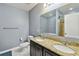 Well-lit bathroom with double sinks, granite counters, and a separate toilet area at 2409 Martins Run, Tavares, FL 32778