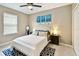 Comfortable bedroom featuring an oversized window and ceiling fan at 2409 Martins Run, Tavares, FL 32778