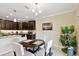 Dining area featuring wood table and chairs with kitchen in the background at 2409 Martins Run, Tavares, FL 32778