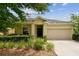 Charming one-story home featuring a two-car garage, manicured landscaping and a covered front porch at 2409 Martins Run, Tavares, FL 32778