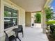 Welcoming front porch featuring a small table with chairs, offering a pleasant outdoor seating area at 2409 Martins Run, Tavares, FL 32778