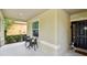 Inviting front porch with outdoor seating and a view of the landscaped front yard at 2409 Martins Run, Tavares, FL 32778