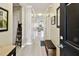 Inviting entry hallway with light wood flooring and views of the living room at 2409 Martins Run, Tavares, FL 32778