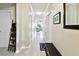 Entry hallway featuring neutral walls, wood-look flooring, and views into the living spaces at 2409 Martins Run, Tavares, FL 32778