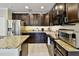 Modern kitchen featuring granite countertops, stainless steel appliances, and ample storage at 2409 Martins Run, Tavares, FL 32778