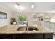 Bright kitchen featuring granite countertops and stainless steel sink at 2409 Martins Run, Tavares, FL 32778