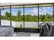 Covered and screened lanai with a view of the backyard and white vinyl fence at 2409 Martins Run, Tavares, FL 32778