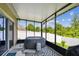 Screened-in lanai with an outdoor hot tub and view of the backyard at 2409 Martins Run, Tavares, FL 32778