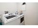 White laundry room featuring a GE washer and dryer with a white wire laundry basket at 2409 Martins Run, Tavares, FL 32778