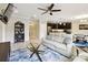 Open-concept living area with wood floors, a ceiling fan, and comfortable seating at 2409 Martins Run, Tavares, FL 32778