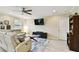 Cozy living room featuring a ceiling fan, a comfortable sofa, and entertainment center at 2409 Martins Run, Tavares, FL 32778