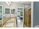 The main bathroom features double sinks with granite countertops and a tiled shower at 2409 Martins Run, Tavares, FL 32778