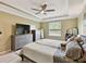 Spacious main bedroom showcasing large windows and comfortable furnishings at 2409 Martins Run, Tavares, FL 32778