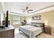 Tranquil main bedroom featuring a tray ceiling and soothing color palette at 2409 Martins Run, Tavares, FL 32778