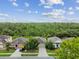 Street view showcasing attractive homes with well-kept front yards, complemented by lush greenery, and neighborhood charm at 2409 Martins Run, Tavares, FL 32778