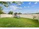 Backyard featuring a wooden playset with swings and a slide on a grassy lawn at 2777 Monticello Way, Kissimmee, FL 34741