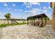 Backyard featuring a covered patio with an outdoor kitchen, stone pavers, and a fenced yard at 2777 Monticello Way, Kissimmee, FL 34741