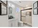 Stylish bathroom with an oval mirror, white vanity, and a sleek glass-enclosed shower at 2777 Monticello Way, Kissimmee, FL 34741
