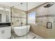 Elegant bathroom showcasing a freestanding tub, glass shower, and stylish vanity with sleek fixtures at 2777 Monticello Way, Kissimmee, FL 34741