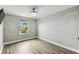 Bright bedroom features hardwood floors, base trim, crown molding, and natural light from the window at 2777 Monticello Way, Kissimmee, FL 34741