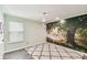 Bedroom with wood floors, moon chandelier, and a nature-inspired accent wall showcasing a tree at 2777 Monticello Way, Kissimmee, FL 34741