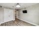 Bedroom with wood floors, ceiling fan, and closet; view of upstairs hall and staircase at 2777 Monticello Way, Kissimmee, FL 34741