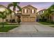 Charming two-story home featuring a well-maintained lawn, mature palm trees, and a two-car garage at 2777 Monticello Way, Kissimmee, FL 34741