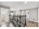 Hallway and staircase with decorative railing, wood floors, and neutral wall colors throughout at 2777 Monticello Way, Kissimmee, FL 34741