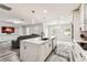 Open-concept kitchen features an island with marble countertops, modern lighting, and stainless steel appliances at 2777 Monticello Way, Kissimmee, FL 34741