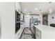Bright kitchen features white cabinetry, stainless steel appliances, and a large marble countertop island at 2777 Monticello Way, Kissimmee, FL 34741