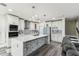 Modern kitchen featuring a large island, stainless steel appliances, and sleek white cabinetry at 2777 Monticello Way, Kissimmee, FL 34741