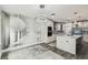 Modern kitchen featuring a large island, stainless steel appliances, and sleek white cabinetry at 2777 Monticello Way, Kissimmee, FL 34741