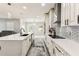 Spacious kitchen with a large island, stylish lighting, stainless steel appliances, and light wood flooring at 2777 Monticello Way, Kissimmee, FL 34741