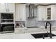 Well-equipped kitchen features a tile backsplash, stainless steel appliances, and white marble countertops at 2777 Monticello Way, Kissimmee, FL 34741