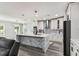 Modern kitchen featuring a large island, stainless steel appliances, and sleek white cabinetry at 2777 Monticello Way, Kissimmee, FL 34741