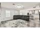 Open-concept living room showcasing a plush sectional sofa, contemporary lighting, and stylish flooring at 2777 Monticello Way, Kissimmee, FL 34741