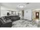 Open-concept living room showcasing a plush sectional sofa, contemporary lighting, and stylish flooring at 2777 Monticello Way, Kissimmee, FL 34741