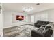 Cozy living room features a modern fireplace, contemporary chandelier, and stylish wood flooring at 2777 Monticello Way, Kissimmee, FL 34741