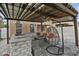 An outdoor kitchen featuring grill, refrigeration, cooking & dining space under covered patio at 2777 Monticello Way, Kissimmee, FL 34741