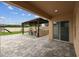 Covered patio area with stone pavers, an outdoor kitchen, and a view of the backyard at 2777 Monticello Way, Kissimmee, FL 34741