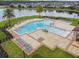 Aerial view of a stunning community pool with ample seating and a meticulously designed deck area at 2777 Monticello Way, Kissimmee, FL 34741