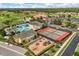 Aerial view featuring pool, clubhouse, playground, tennis court, green lawn and residential housing at 3578 Cortland Dr, Davenport, FL 33837