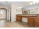 Bathroom with dual sinks, wooden cabinets, granite counters, and a glass enclosed walk-in shower at 3578 Cortland Dr, Davenport, FL 33837