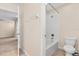 Bathroom featuring ceramic tile flooring, tub with shower, and views to carpeted living area at 3578 Cortland Dr, Davenport, FL 33837