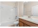 Bright bathroom featuring a shower over tub with ceramic tile surround and a vanity with solid surface counter at 3578 Cortland Dr, Davenport, FL 33837